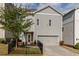 Back exterior view featuring a two-car garage and fenced-in patio area, offering practical convenience and private outdoor space at 2467 Davis Se Dr, Smyrna, GA 30080