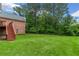 Expansive backyard with lush green lawn, mature trees, and stairs leading to a deck at 5510 Conway Dr, Marietta, GA 30068