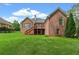 Expansive backyard featuring a well-maintained lawn and the rear exterior of a traditional brick home at 5510 Conway Dr, Marietta, GA 30068