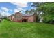 Spacious backyard featuring a well-maintained lawn, a deck, and the exterior of a brick home at 5510 Conway Dr, Marietta, GA 30068