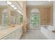 Large bathroom with dual sinks, a tub, and a window for natural light at 5510 Conway Dr, Marietta, GA 30068