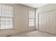Bedroom featuring neutral decor, windows, and closet with bi-fold doors at 5510 Conway Dr, Marietta, GA 30068