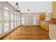 Bright breakfast nook with large windows, hardwood floors, and a chandelier above the table at 5510 Conway Dr, Marietta, GA 30068