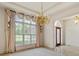 Open dining room with large windows, chandelier, and elegant drapery at 5510 Conway Dr, Marietta, GA 30068