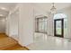 Foyer with decorative window, marble floors, chandelier and hardwood flooring beyond at 5510 Conway Dr, Marietta, GA 30068