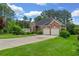 Charming brick home with a two-car garage and lush green lawn at 5510 Conway Dr, Marietta, GA 30068