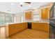 Open kitchen design with wood cabinetry, white countertops, and wooden floors at 5510 Conway Dr, Marietta, GA 30068