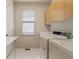 Bright laundry room features washer, dryer, window and storage cabinets at 5510 Conway Dr, Marietta, GA 30068