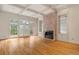 Living room with hardwood floors, fireplace, and large windows with deck access at 5510 Conway Dr, Marietta, GA 30068