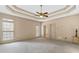 Spacious main bedroom featuring neutral decor, carpet, and tray ceiling at 5510 Conway Dr, Marietta, GA 30068