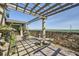 Spacious stone balcony featuring pillars, trellis, and panoramic city views in the distance at 147 15Th Ne St # 16C, Atlanta, GA 30309