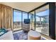 Comfortable sitting area leading to outdoor balcony with beautiful stone railing at 147 15Th Ne St # 16C, Atlanta, GA 30309