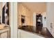 Stylish bar area with custom cabinetry, stone countertop, and decorative accents at 147 15Th Ne St # 16C, Atlanta, GA 30309
