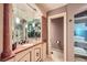 Bathroom featuring marble accents, a large vanity with double sinks, and a glass-enclosed shower at 147 15Th Ne St # 16C, Atlanta, GA 30309