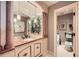 Elegant bathroom features a marble countertop, decorative mirrors and an adjoining toilet room at 147 15Th Ne St # 16C, Atlanta, GA 30309