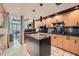 Modern kitchen featuring granite countertops and backsplash, an island, and light wood cabinets at 147 15Th Ne St # 16C, Atlanta, GA 30309
