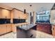 Modern kitchen features wood cabinetry, granite countertops, and a view to the eating area at 147 15Th Ne St # 16C, Atlanta, GA 30309