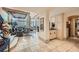 Elegant living room featuring travertine floors, bar, and ample natural light at 147 15Th Ne St # 16C, Atlanta, GA 30309