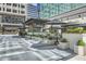 Stylish outdoor seating area with umbrellas, planters, and string lights perfect for dining al fresco in the city at 147 15Th Ne St # 16C, Atlanta, GA 30309