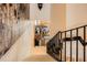 Elegant staircase featuring iron railings and decorative wall accents leading to the living area with great natural light at 147 15Th Ne St # 16C, Atlanta, GA 30309