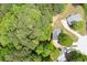 The house is nestled among mature trees providing a serene and private setting, aerial view at 174 Cannon Pl, Dallas, GA 30157