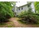 The home's rear exterior showcases the siding, windows, trees, and deck at 174 Cannon Pl, Dallas, GA 30157
