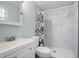 Bathroom featuring a white vanity with a modern sink and a walk-in shower with marble-style tiling at 174 Cannon Pl, Dallas, GA 30157