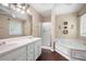 Bright bathroom featuring a double vanity, a walk-in shower, and a relaxing soaking tub at 174 Cannon Pl, Dallas, GA 30157