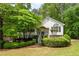 Charming home featuring lush landscaping, stone accents, and a well-manicured lawn, all nestled amongst mature trees at 174 Cannon Pl, Dallas, GA 30157