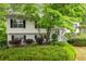 Inviting two-story house with well-maintained landscaping, complemented by dark shutters and a stone entryway at 174 Cannon Pl, Dallas, GA 30157