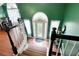 Elegant foyer featuring a hardwood staircase, complemented by soaring ceilings and views to the dining area at 174 Cannon Pl, Dallas, GA 30157
