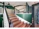 Welcoming foyer with hardwood stairs, wrought iron banister, and an open view to the living area, filled with natural light at 174 Cannon Pl, Dallas, GA 30157