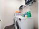 Laundry room with modern washer and dryer with storage racks at 174 Cannon Pl, Dallas, GA 30157