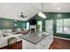 Open-concept living area with fireplace, green walls, and natural light at 174 Cannon Pl, Dallas, GA 30157