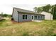 This home has blue siding, a small patio, and a green lawn at 1810 Forkview Ct, Lawrenceville, GA 30044