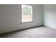 This bedroom has a window with natural light and neutral carpeting at 1810 Forkview Ct, Lawrenceville, GA 30044