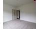 This bedroom has neutral carpeting and double doors for closet space at 1810 Forkview Ct, Lawrenceville, GA 30044