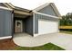 Charming gray exterior featuring a two-car garage and inviting entrance with the house number at 1810 Forkview Ct, Lawrenceville, GA 30044