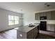 Well-lit kitchen featuring an island with a sink and stainless steel appliances at 1810 Forkview Ct, Lawrenceville, GA 30044