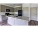 Modern kitchen features gray cabinets, granite countertops, and stainless steel appliances at 1810 Forkview Ct, Lawrenceville, GA 30044