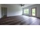 Spacious living room with wood-style flooring, natural light, and access to the outdoors at 1810 Forkview Ct, Lawrenceville, GA 30044