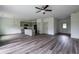 Spacious open-concept living area featuring modern flooring and a ceiling fan at 1810 Forkview Ct, Lawrenceville, GA 30044