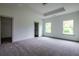 Large main bedroom featuring tray ceilings, carpeted floors, and two large windows at 1810 Forkview Ct, Lawrenceville, GA 30044