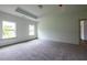 Spacious main bedroom with a tray ceiling, carpet, and bright natural light at 1810 Forkview Ct, Lawrenceville, GA 30044