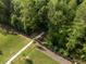 Aerial view of a walking path surrounded by mature trees and lush greenery, offering a peaceful outdoor experience at 3747 Silvery Way, Powder Springs, GA 30127