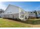 View of the backyard and covered patio of a two-story home with brick and vinyl siding at 3747 Silvery Way, Powder Springs, GA 30127