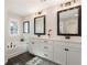 Modern bathroom with dual vanity, soaking tub, elegant mirrors, and decor at 3747 Silvery Way, Powder Springs, GA 30127
