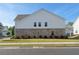 Rear view of a two-story home with brick accents and well-maintained lawn at 3747 Silvery Way, Powder Springs, GA 30127