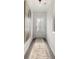 Bright hallway with a textured runner, neutral walls, and a stylish front door at 3747 Silvery Way, Powder Springs, GA 30127