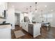 Bright kitchen featuring white cabinets, stainless steel appliances, and a central island with pendant lighting at 3747 Silvery Way, Powder Springs, GA 30127